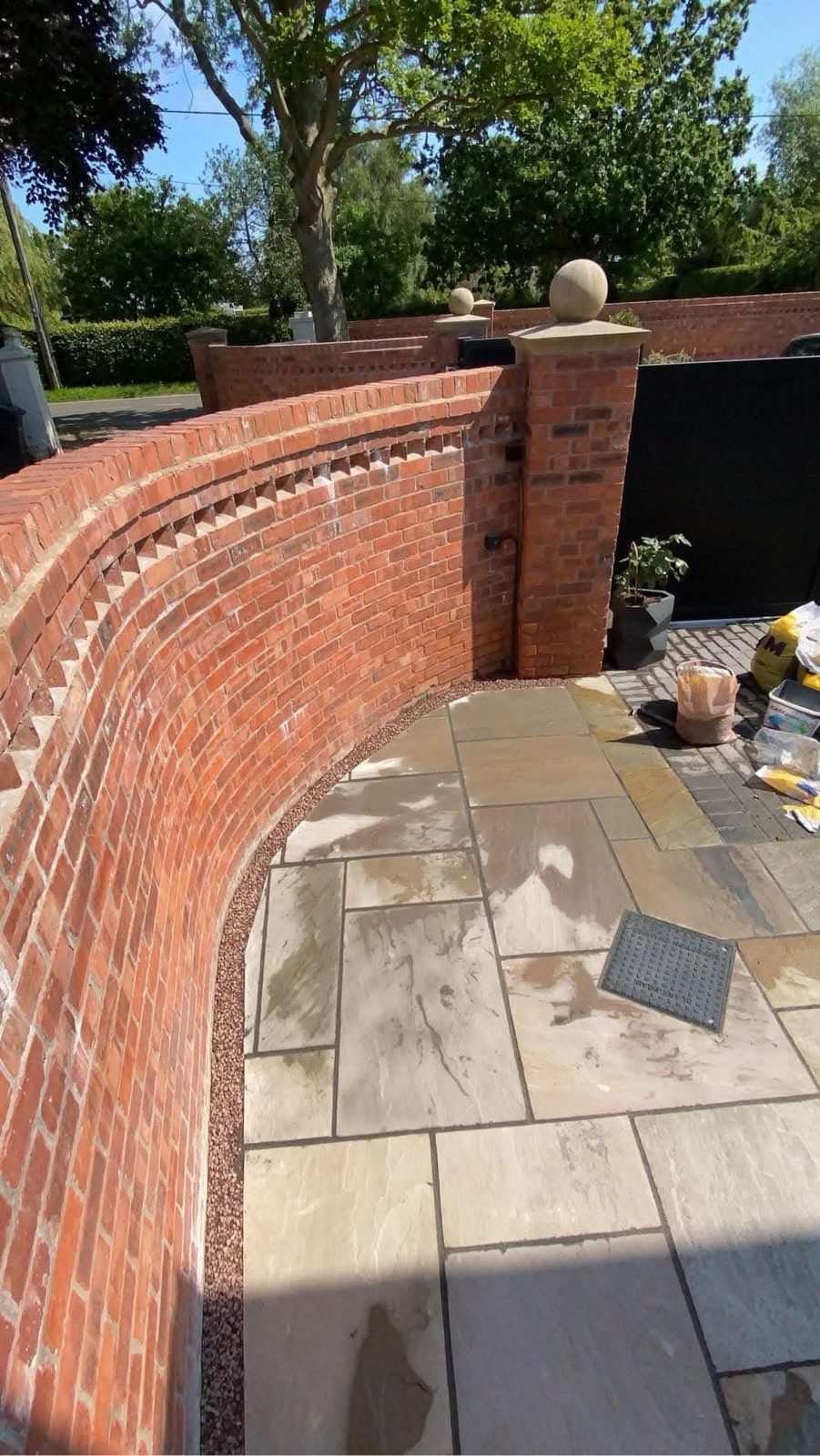 Curved brick garden wall with patio